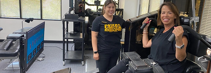 Emily Ortega With Patient In MedX Spinal Strengthening Machine