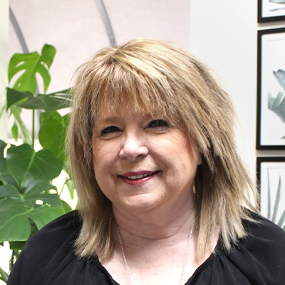 Office Manager Karen Howell Smiling In Black Shirt