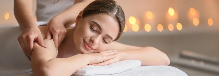 Lady Receiving A Massage In Front Of Blurred Background