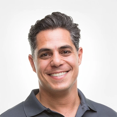 Chiropractor Sevak Khodabakhshian Smiling In Black Polo