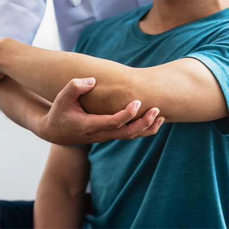 Patient Receiving Elbow Mobilization Therapy