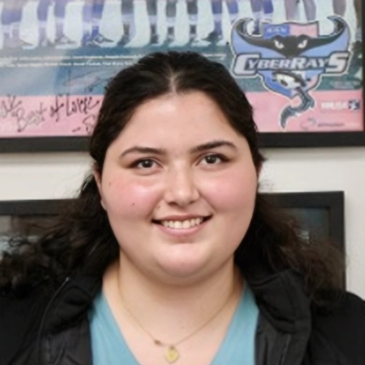 Rehabilitation Aide Karla Redondo Smiling In Blue Shirt