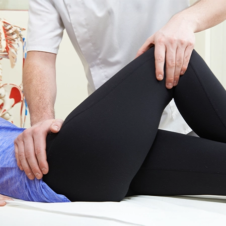 Patient Lying Down Receiving Knee Mobilization Therapy