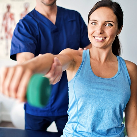 Woman Doing Assisted Shoulder Mobilization With A Small Weight